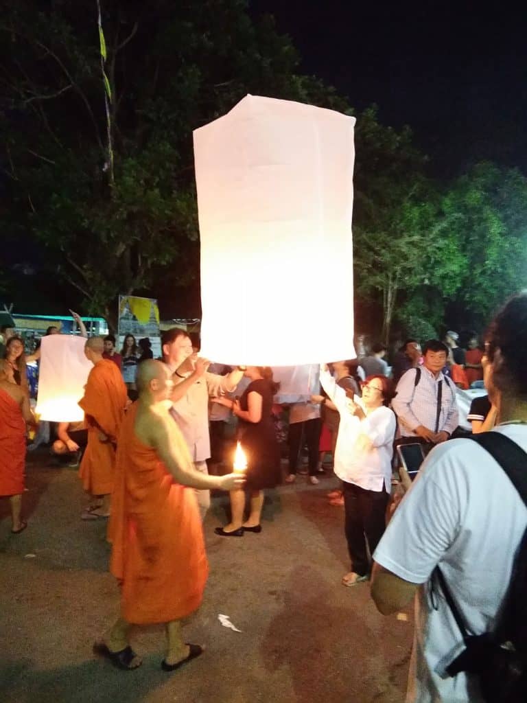 lighting Khom Loy lanterns at Loy Krathong festival