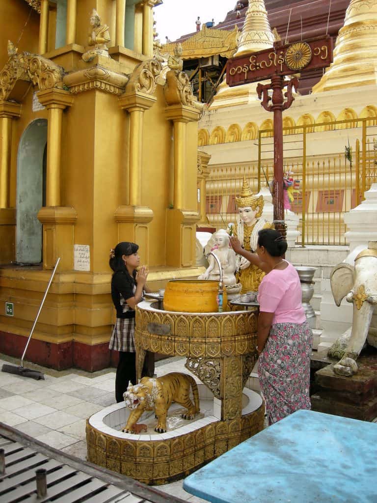 pouring water over Buddha image Yangon