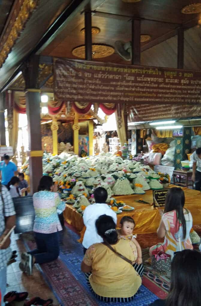making fortune wishes to the Buddha of Success at Wat Doi Kham