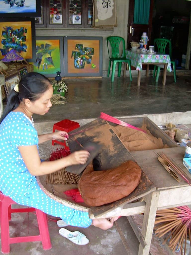 girl making incense in Hue