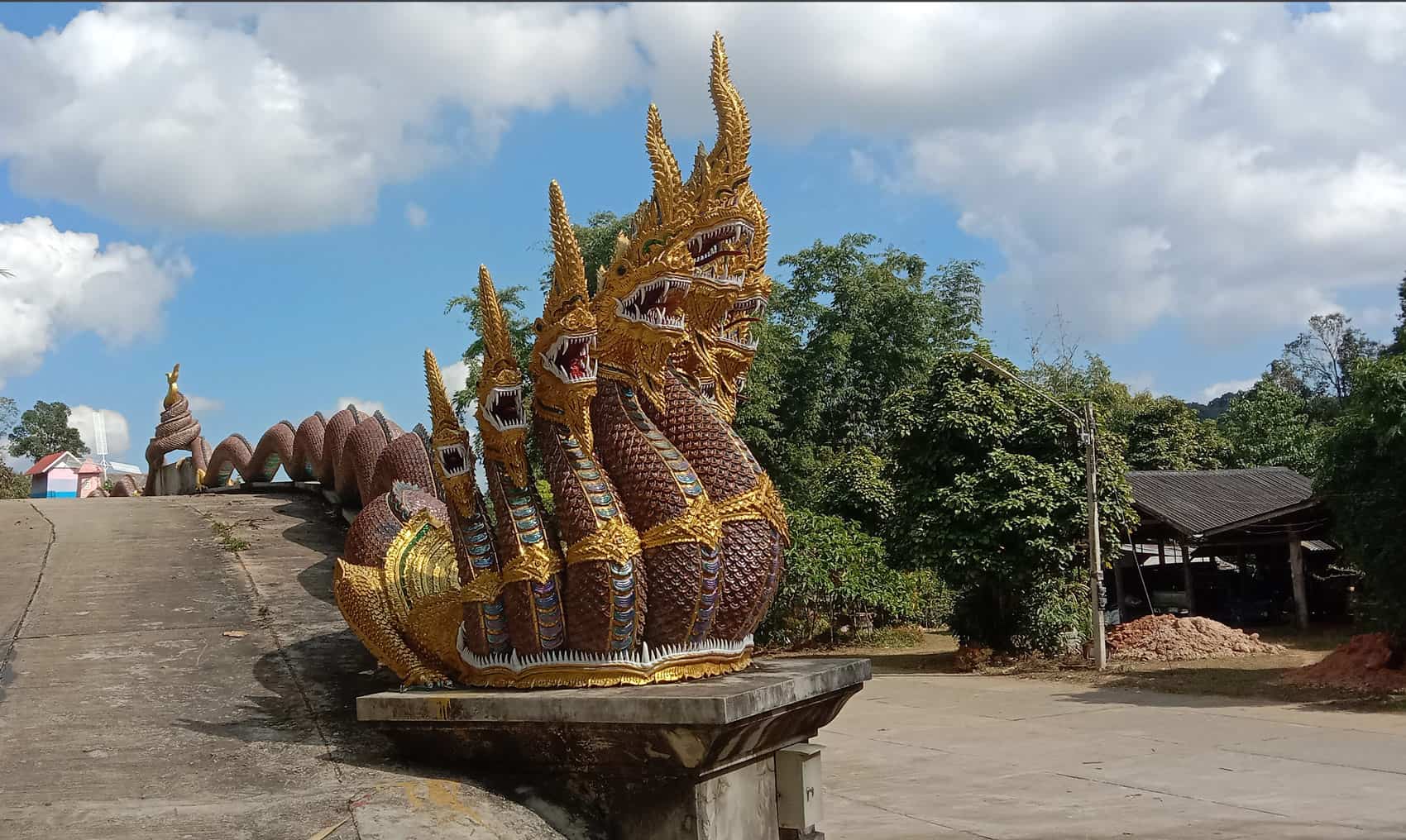 nagas at Buddha footprints temple entrance by Meanwhile in Thailand